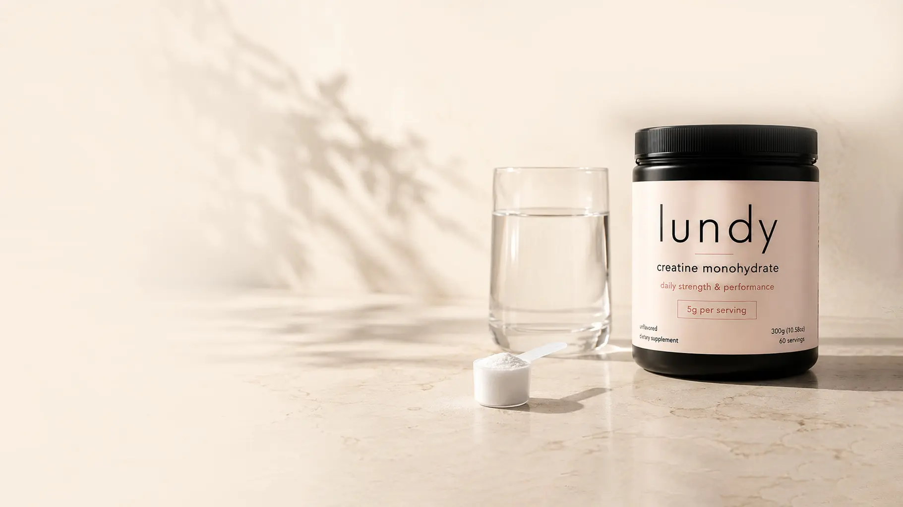 Model drinking water after a workout, warm natural light, soft neutral tones